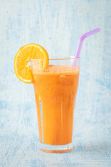 carrot and orange fresh juice on blue table