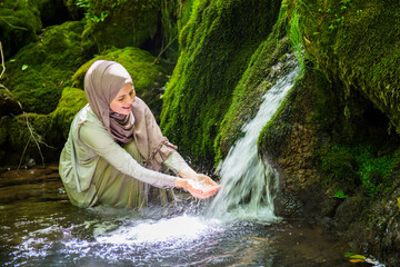 A young Muslim woman with hijab untouched nature, enjoys the natural resources, Paradise on Earth