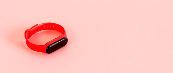 Smart watch on pastel pink background.