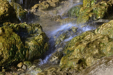 Naklejka na ściany i meble The stream water over the plaster rock of the Plakun waterfall