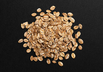 Top view of oat flakes on black background