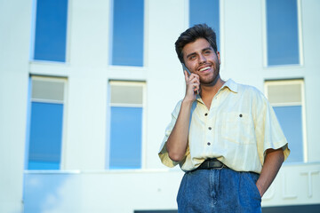 man talking on his mobile phone outside his work office