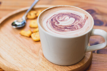 Cup of coffee and biscuit on wooden plate. Drink fresh daily.