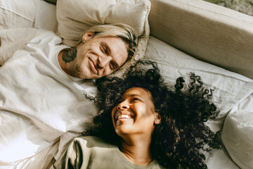 Couple in love rest together, smiling boyfriend and girlfriend in bed. Affection between people,...