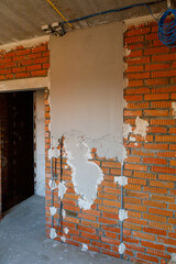 Gypsum plaster is applied to a brick wall. Plastered brick wall in the apartment