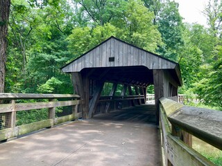 covered wooden bridge over river