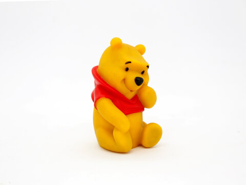 Winnie the Pooh. Teddy bear belonging to Christopher Robin. Honey loving yellow bear. Walt Disney character from books, movies and television series. Toy for young children. Plastic doll.