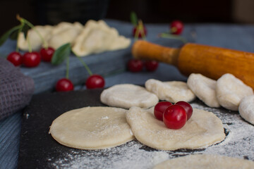 Cooking dumplings with cherries. A traditional dish of the Eastern Slavs. The concept is vegetarianism.