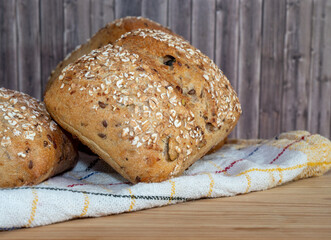 Baked bun soaked in sesame seeds and oatmeal isolated on white background. 