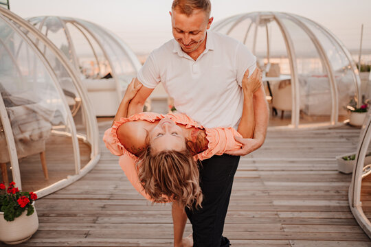 a man and a woman in love dance to a rooftop cafe on a date.