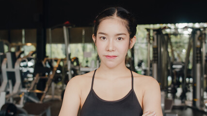 Fototapeta na wymiar Happy Asian healthy sport woman trainer with sportswear smile looking at camera feel cheerful and fresh after workout in gym, People training use in fitness class, sport and healthy lifestyle concept.
