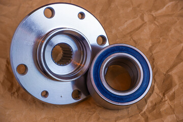 Auto parts. Automotive hub and wheel bearing. Close-up photo of details on craft paper.