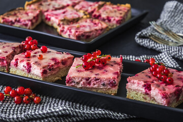 Pieces of creamy red currant pie on a black plate