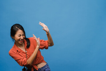 Young Asia lady feel happiness with positive expression, joyful surprise funky, dressed in casual cloth isolated on blue background. Happy adorable glad woman rejoices success. Facial expression.