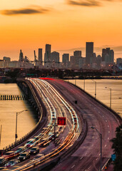 Fototapeta premium city skyline at sunset beautiful view traffic Miami Florida usa buildings cars road panorama sea bridge sky color orange travel 