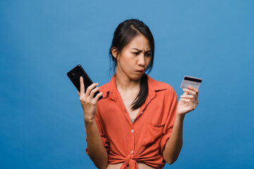 Young Asia lady using phone and credit bank card with negative expression, excited screaming, cry...