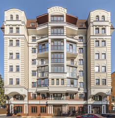 Fototapeta premium Facade of modern multi-storey brown beige building in the city. Space for text. High quality photo