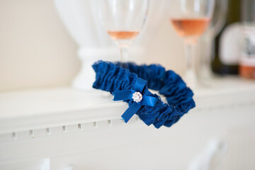 Wedding blue garter lies on a table and waiting on bride