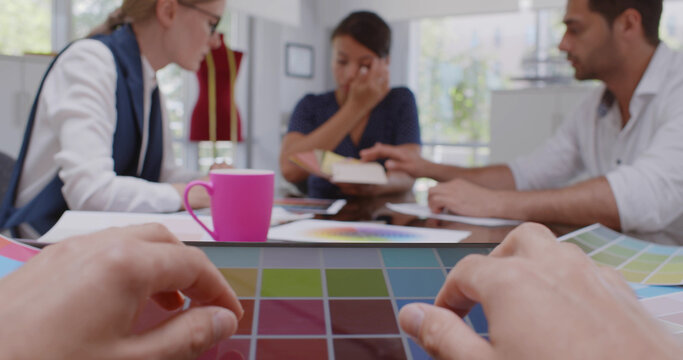 Cropped shot of fashion designer looking at new color palettes on tablet in office