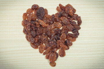 Heart shaped healthy raisins containing vitamins and minerals. Nutritious eating