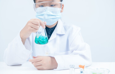 Young Scientists shaking blue liquid chemical in Erlenmeyer flask