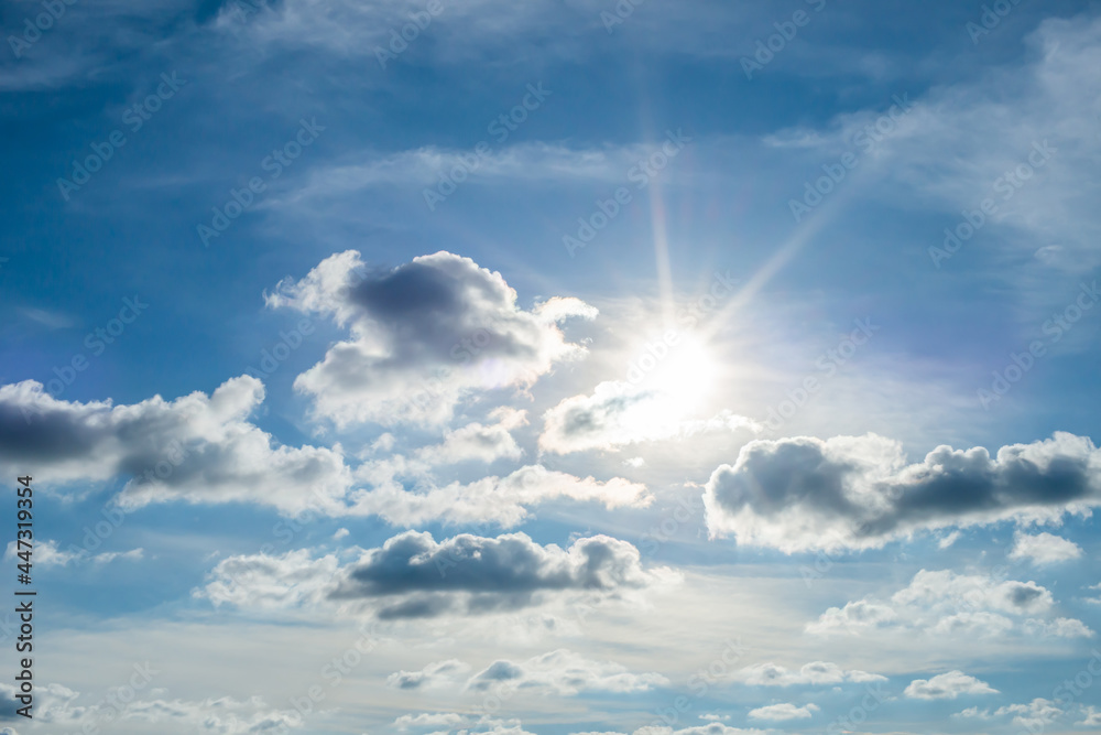 Wall mural the light of the sun shining through the clouds in the sky