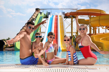Happy family at poolside in water park