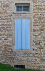 old window with light blue shutters