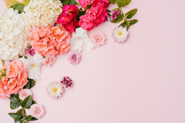 Composition of mixed flowers on pink background. top view, copy space.