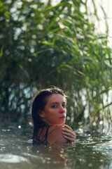 Sensual fasion portrait of woman in the water. Summer emotional, beautiful portrait of a swimming woman resting in the water
