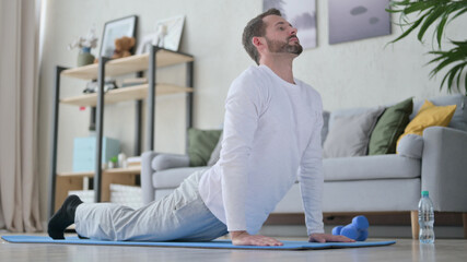 Mature Adult Man doing Yoga at Home