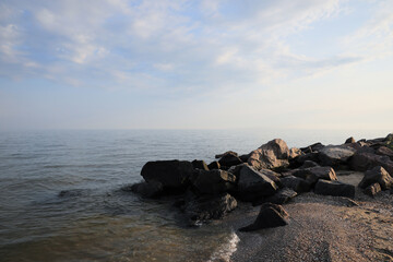 Fototapeta na wymiar Beautiful view sandy sea beach with rocks