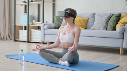 Woman Doing Meditation with VR Set on Yoga Mat 