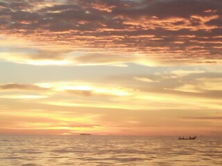 Naklejka na ściany i meble Sunset. Dramatic sunset sky with clouds. Dramatic sunset over the sea