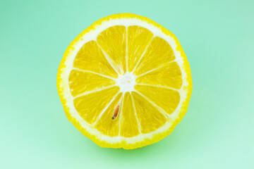 Close up photo of lemon texture on the blue background. Fruit cut in half, inside, macro view. Beautiful natural wallpaper.
