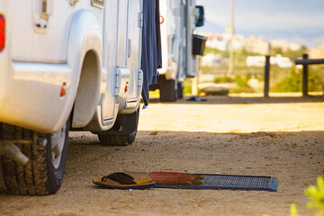 Flip flops on wiper in front of camper car