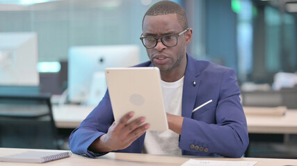 Young African Businessman Doing Video Chat on Tablet in Office