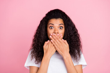 Photo of scared impressed dark skin lady wear white t-shirt arms cover lips isolated pink color background