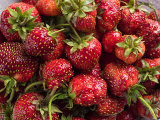 Freshly picked sweet red strawberries with cuttings close-up. Strawberry background. Food background. Vegetarian snack. View from above. Wallpaper. Horizontally