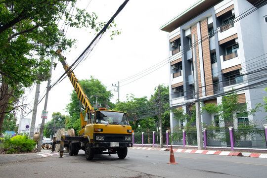 electricians repairing wire of the power line on electric power pole