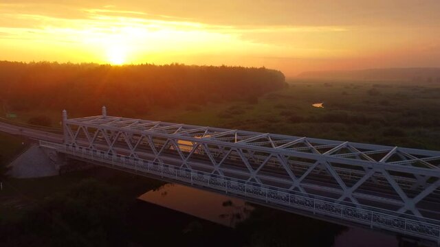 bridge over the river shown during sunrise
