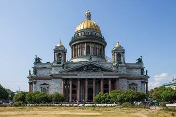 Fototapeta na wymiar the beautiful facade of St. Isaac's Cathedral with a golden dome and monumental columns on a clear sunny summer day in Saint-Petersburg Russia