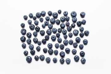 Studio picture of blueberries spread on the white background.
