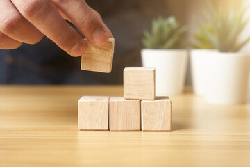 hands of businessmen, stacking wooden blocks into steps, success and business target concept, project management, company strategy development. background                             