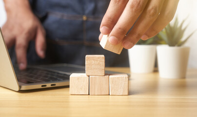 hands of businessmen, stacking wooden blocks into steps, success and business target concept, project management, company strategy development. background