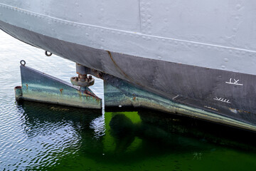 rudder of an old freight ship with reveted hull