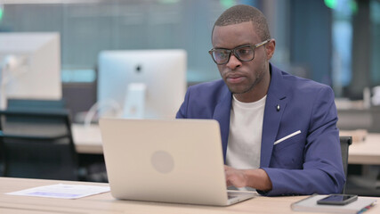 Young African Businessman Working on Laptop in Office