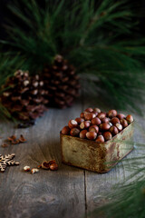 New year composition background with hazelnuts in box and bokeh, christmas mood
