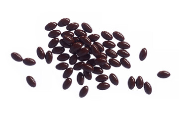 Brown fish oil capsules, vitamins isolated on a white background. Pile of fish oil in gelatin capsules.