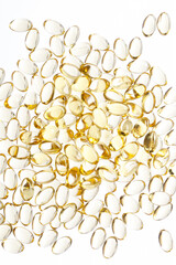 Golden fish oil capsules, vitamins isolated on a white background. Fish oil in gelatin capsules. Fish oil pile.
